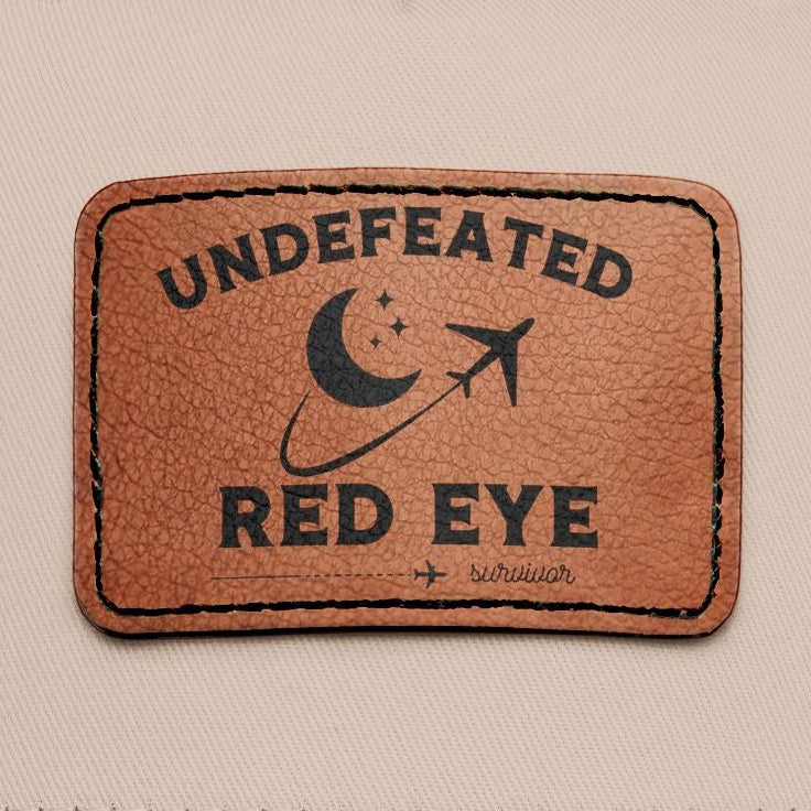 Close up of leather patch with "undefeated red eye survivor"