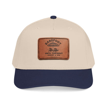 Beige and navy cap with a brown leather patch featuring "Barefoot Until Checkout Resort & Spa"  on a white background