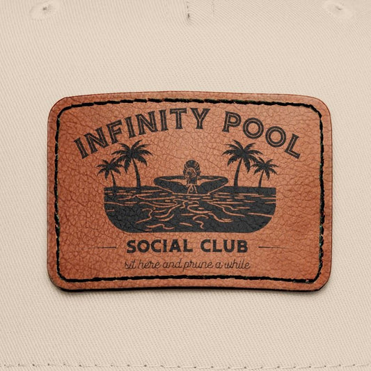 Close up of patch on hat 'infinity pool social club'