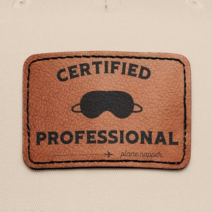 Beige and black  cap with a leather patch featuring "Certified Professional Plane Napper"