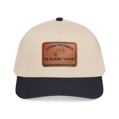 Beige and green cap with a brown leather patch displaying "Living paycheck to planet ticket"