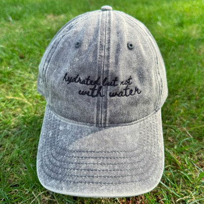 "Hydrated but not with water" - Funny Travel Hat for Beach Lovers-  on grass