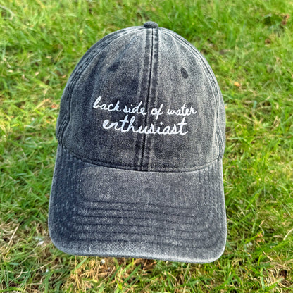 "Back side of water enthusiast" Funny Travel Hat for Theme Park Lovers - in grass